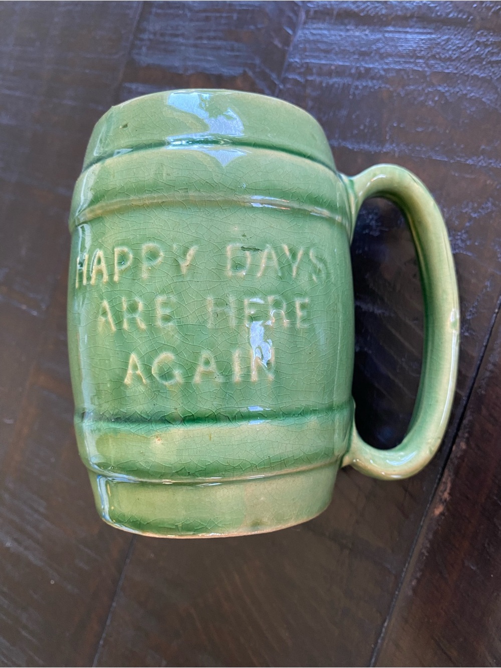 This is a green glazed Hull Pottery #497 stoneware mug with raised lettering